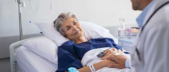 Einzelzimmer im Krankenhaus: Frau im Krankenbett